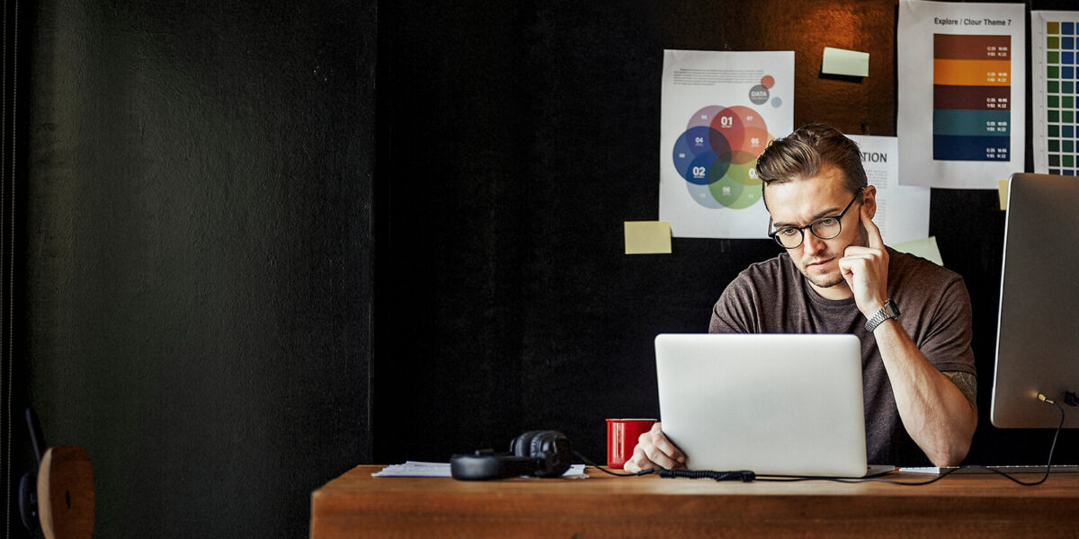 One guy working with a laptop