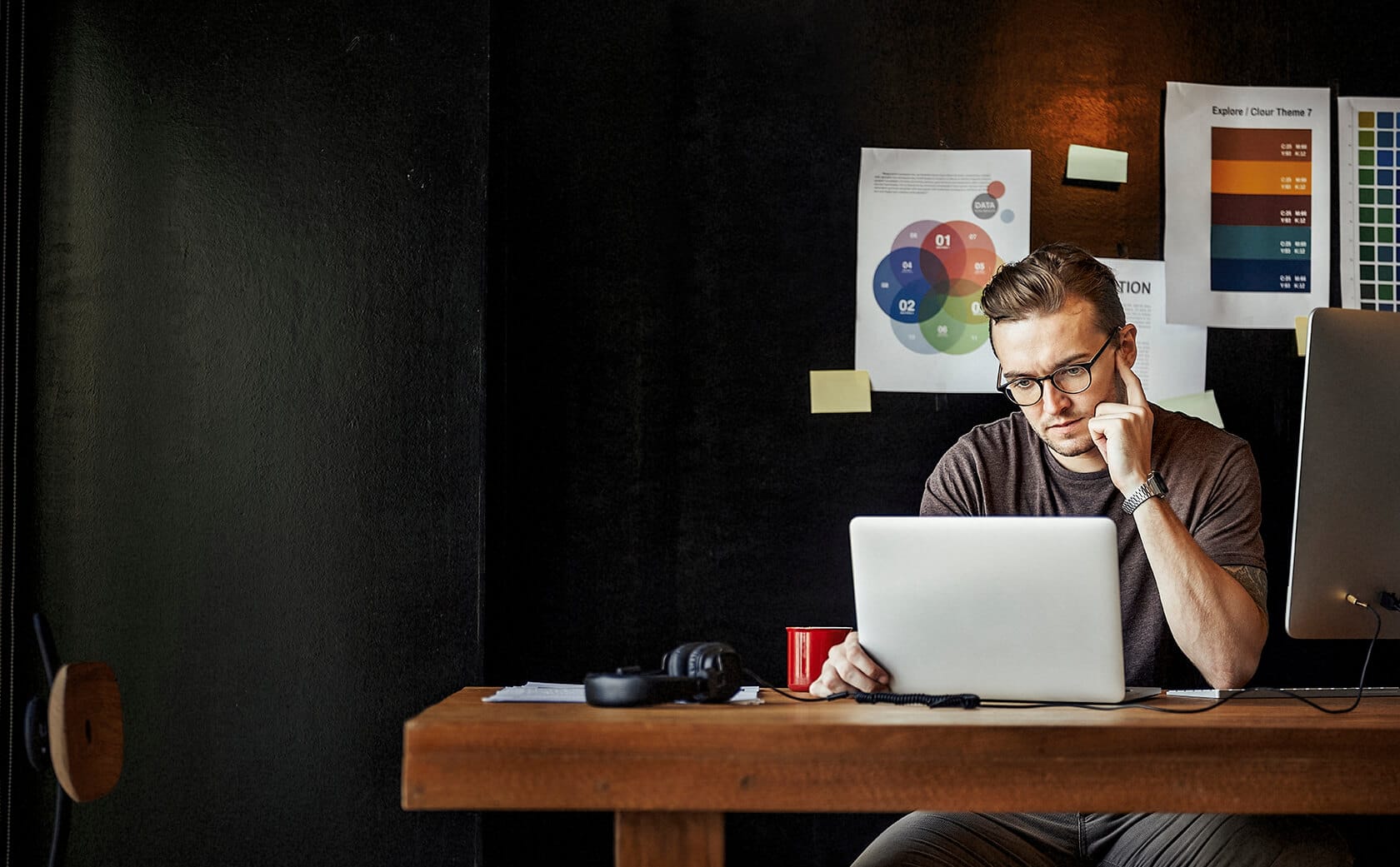 One guy working with a laptop