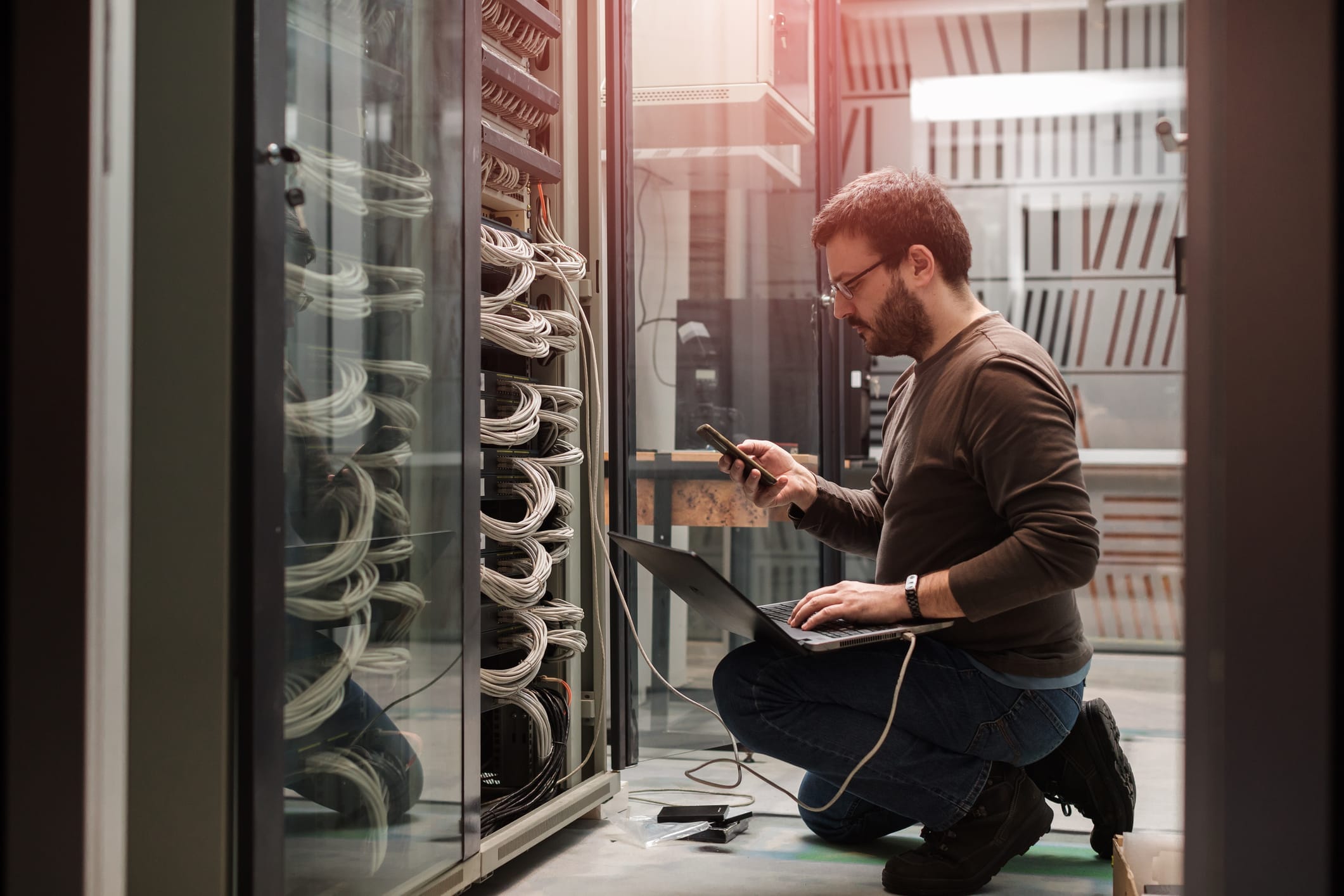 IT professional working on network server equipment