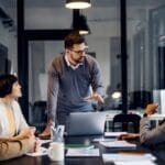 CTO & Consulting CTO Services IT Consulting Male Leader in conference room leading IT Strategy