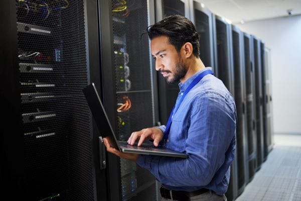 IT Network Server Engineer working on server rack