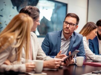 Group is people discussing IT in conference room