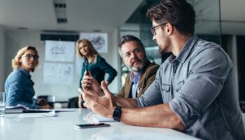 Businessman putting forward his suggestions to team Managed IT services company providing IT consulting to clients in conference room