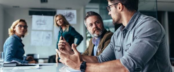 Strategic IT Meeting Managed IT Group of four people in a conference room discussing IT strategy